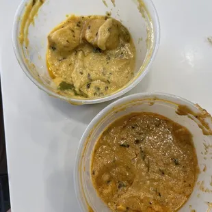 Butter chicken on top (yellow) and sahi paneer on bottom (orange)