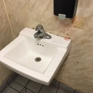 ows a sink in a public restroom