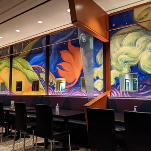 a colorful mural on the wall of a restaurant