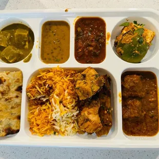 Saag paneer, daal makhni, fish curry, amritsari paneer, chicken curry, chicken kabab, and naan.