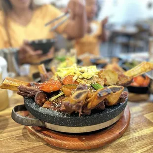 Galbi Jjim- Short ribs, carrot, potato, rice cake, mushroom, egg, green onion, white onion