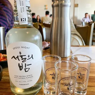 a bottle of gin and shot glasses