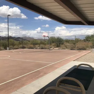Inside the basketball court under the shaded seating area