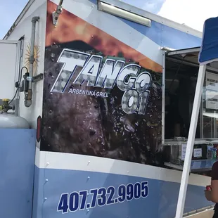 a man standing in front of a food truck