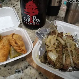 Beef empanadas and homemade sausage halfed with onions