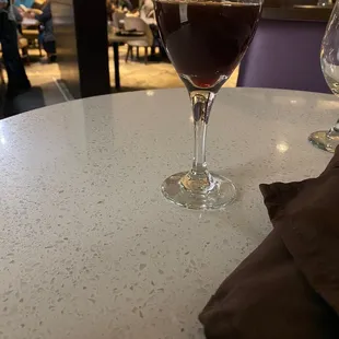 a glass of wine on a table