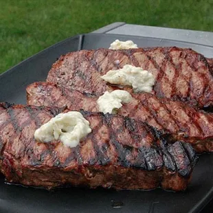 two steaks on a black plate
