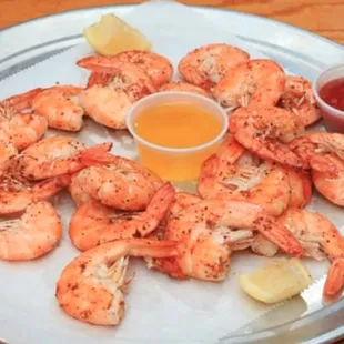 a plate of shrimp with dipping sauce
