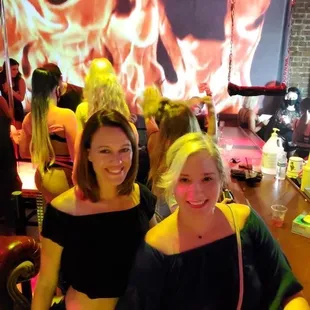 two women sitting at a bar