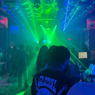 a man in a black t - shirt at a party