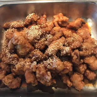 a dish of chicken with sesame seeds