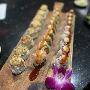 a variety of sushi on a wooden board