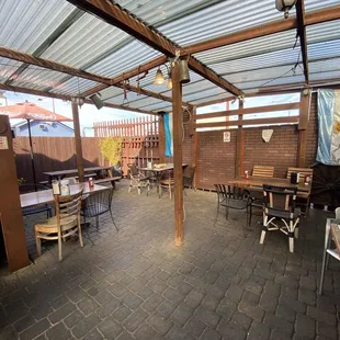 a patio with tables and chairs