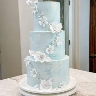 Wafer paper florals cascade around this beautiful Quinceañera Cake
