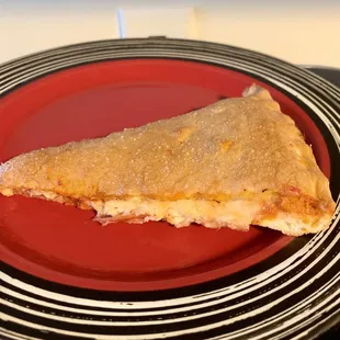 a slice of pizza on a red plate