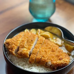 A simple yet perfect lunch.  Katsu Curry Don. Fried pork, rice, curry, potatoes, and carrots.