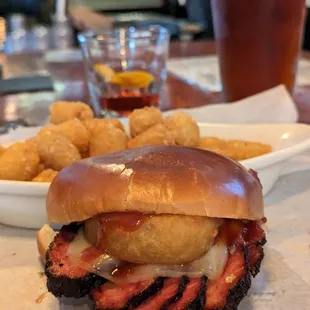 a pulled pork sandwich and tater tots