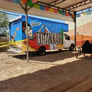 a food truck parked under a tent