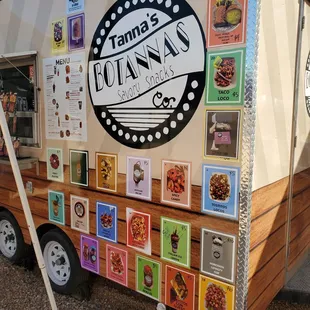 a food truck with many pictures on it