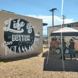 people standing under a tent