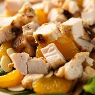 a salad with chicken and oranges