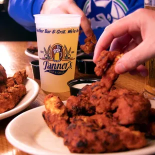 a plate of fried chicken and a glass of beer