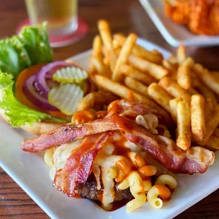 a plate of macaroni and cheese with fries