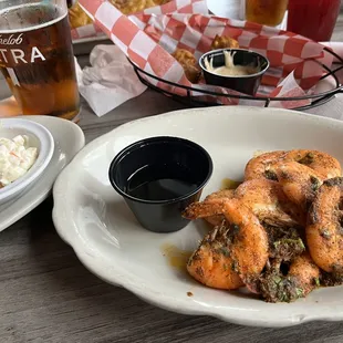 a plate of fried shrimp with a side of coleslaw
