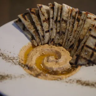 a plate of flatbreads with hummus
