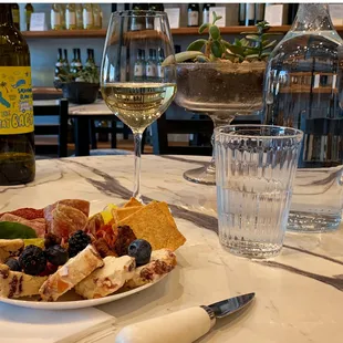 a plate of food and a glass of wine
