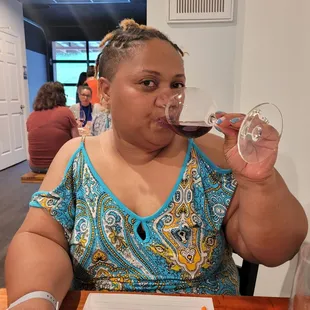 a woman drinking a glass of wine