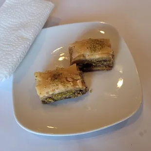 two pieces of baklaa on a white plate