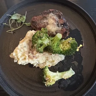 Filet with smashed potatoes and broccoli.