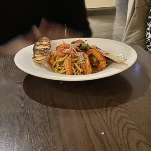  a plate of pasta and shrimp