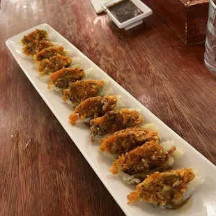 a long rectangular plate of food on a wooden table