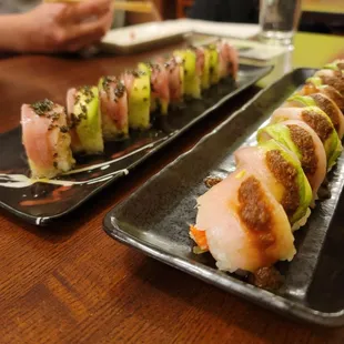 two plates of sushi on a table