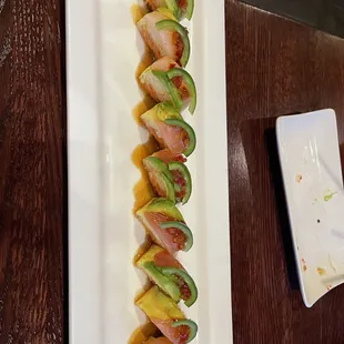 a plate of sushi with avocado