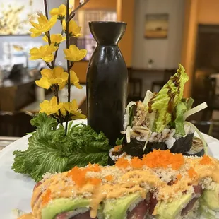 a plate of sushi and vegetables