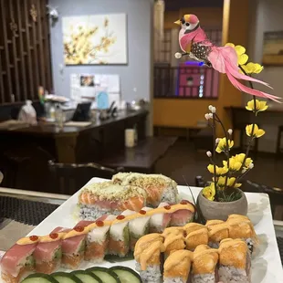 a plate of sushi and cucumbers