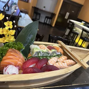 a wooden boat filled with sushi