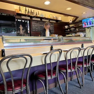 a bar with purple chairs