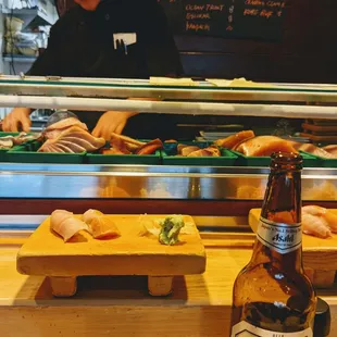 a bottle of beer and sushi