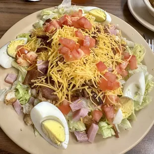 Yummy salad w egg, chicken, bacon and ham.