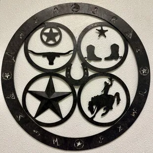 a circular metal sign with a cowboy theme