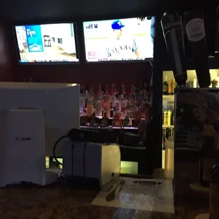 a bar with multiple televisions