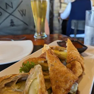 a plate of food and a glass of beer