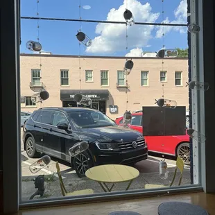 View of the storefront, street parking, and beautiful sky from inside the cafe