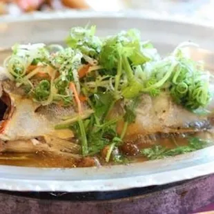 a plate of fish with a spoon in it