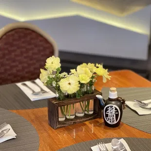 a table setting with flowers in vases