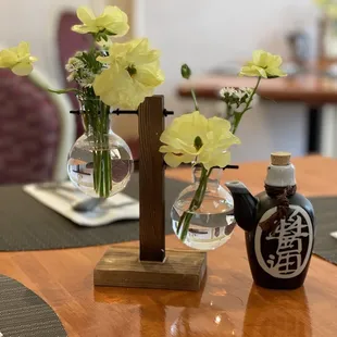 a table setting with flowers in vases